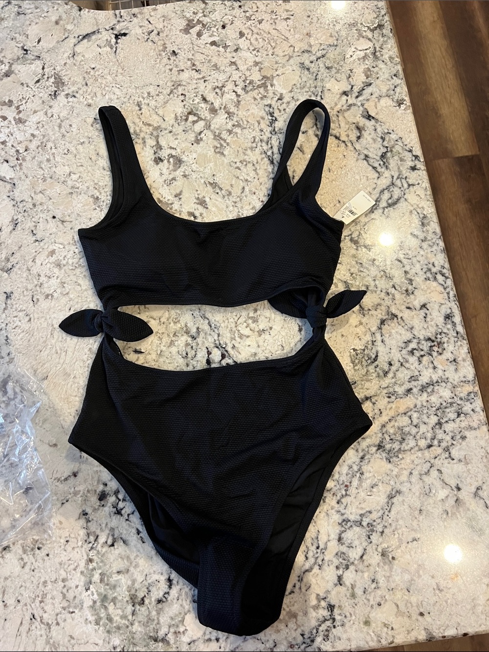 Women’s cut out Black One-Piece Swimsuit with Side Ties. NWT size M
